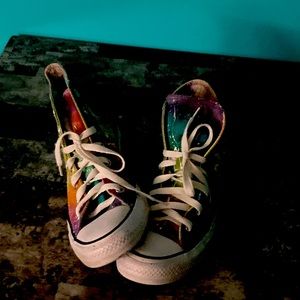 Tie died shoes with the bottom torn up worn a lot